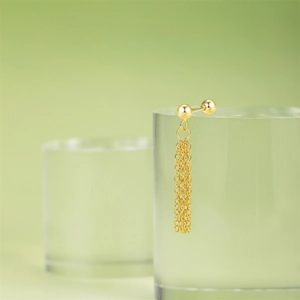 Detail of S925 sterling silver gold fringe tassel stud earrings with star ball design