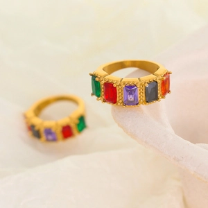Elegant gold rings featuring multi-colored baguette-cut gemstones with milgrain edging