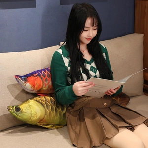 Detail of soft plush golden arowana fish pillow with realistic 3D scale printing patterns