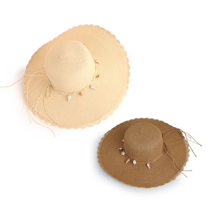 Wide brim straw beach hat with shell decor and wavy edges in cream and coffee tones