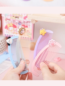 Detail showing four colorful mini cartoon combs with cute puppy and star decorations