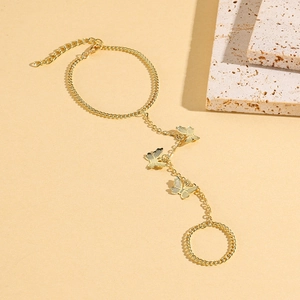 Close-up of golden butterfly slave bracelet with ring and adjustable clasp
