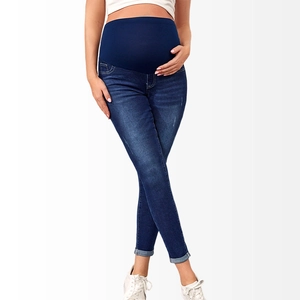 Detail of high-waist maternity skinny jeans with elastic belly support in navy blue