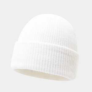 Close-up of a white ribbed knit beanie hat made of soft wool texture on a grey background