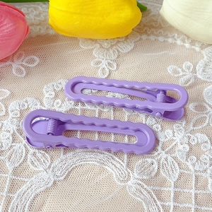 Set of two shiny purple wavy hair clips on decorative lace with spring-clip design