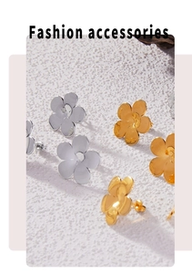 Macro shot of minimalist five-petal flower earrings in matte gold and silver finish