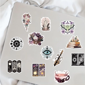 Flat lay of mystery witch stickers featuring dreamcatchers and crystals on a notebook