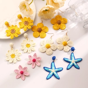 Handmade raffia flower and starfish earrings in bright summer colors and woven texture