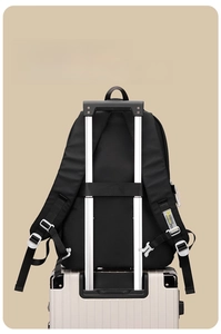 Detail of ergonomic padded shoulder straps and suitcase luggage strap on black backpack