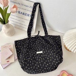 Detail of floral chiffon tote bag with black texture and delicate yellow flower print