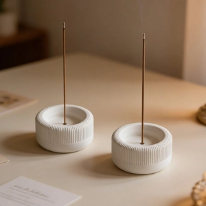 Macro view of white striped cylindrical incense holder mold set with a warm lifestyle vibe