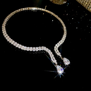 Macro shot of silver-tone collar necklace with double-row zircon and pear-cut water drop pendants