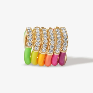 Detailed macro of six gold-plated rings with rainbow enamel colors and zircon accents