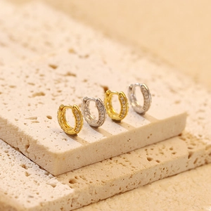 Close-up of gold and silver S925 sterling silver hoop earrings with pavé zircon stones
