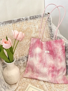 Pink tie-dye tote bag with vertical lace embroidery detail for casual vacation styling