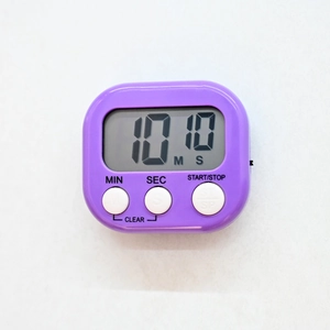 Macro shot of purple square digital timer showing 10:10 on screen with functional buttons