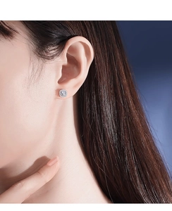 Close-up of model wearing square halo moissanite stud earrings in 925 sterling silver