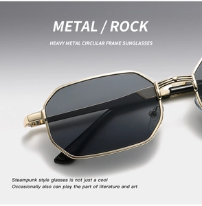 Detail of gold metal hinge and grey lens on punk style polygonal sunglasses
