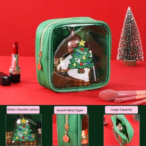Detail of Christmas tree chenille patch and clear window on green makeup bag