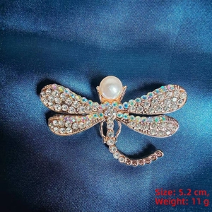 Detail showing elegant dragonfly brooch size 5.2 cm with pearls and crystals