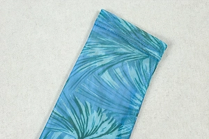 Detail of teal palm leaf print on mesh fabric with high-quality double-stitch sewing