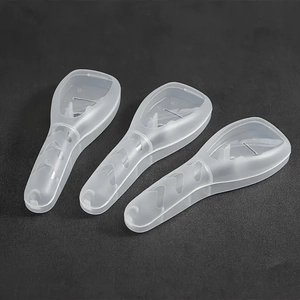 Three translucent plastic razor cases on textured background for travel protection