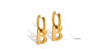 Macro shot of gold-plated letter B earrings showing polished texture and 3.8cm height