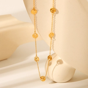 Detail of 18K gold-plated stainless steel necklace with hammered round disc pendants