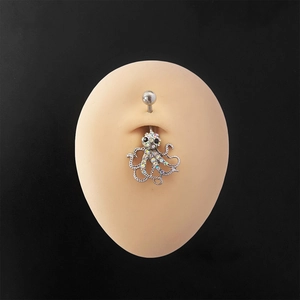 Rainbow octopus navel ring with crystal zircons on a beige silicone belly model