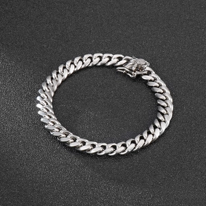 Detail of 8mm silver cuban link chain bracelet featuring a secure box clasp and polished steel finish
