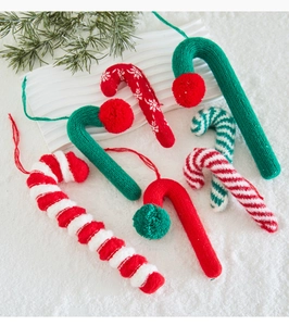 Detail of knitted candy cane ornaments with striped patterns and snowflake textures