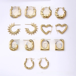 Detail view of various 18K gold-plated titanium steel earrings in heart and floral designs