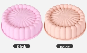 Detail view of pink and beige silicone cake molds with radial sunburst texture patterns