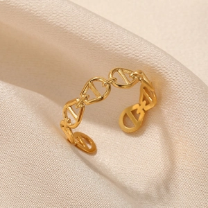 Detail of adjustable gold coffee bean chain link ring on champagne silk fabric