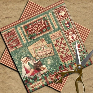 Close-up of vintage Santa scrapbooking papers with festive illustrations and golden scissors