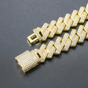 Macro shot of gold cuban link chain with zircon paving on premium black background