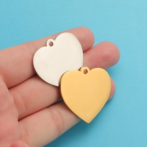 Close-up of 33mm polished heart pendants in gold and silver finish for DIY necklaces
