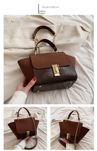 Detail of coffee brown crossbody bag showing crocodile texture and gold metal clasp
