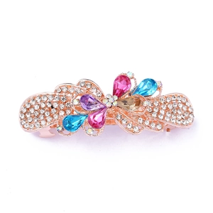 Detail of rose gold alloy hair clip featuring colorful rhinestones and crystal bow design