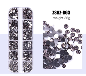 Macro detail of multi-size flatback resin rhinestones in a 12-slot storage box