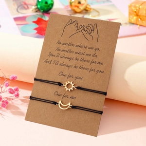 Detail of sun and moon woven bracelets on a sentimental message card for best friends