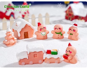 Miniature Christmas gingerbread man set with pink festive house and winter scene decor