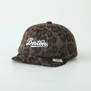Detail of embroidered Boston text and leopard print texture on cotton baby hat