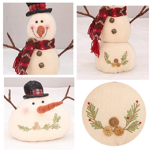 Detail shots of linen snowman doll with embroidered patterns and twig arms for Christmas decor
