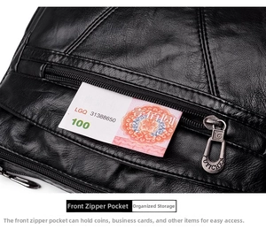 Détail macro du sac en cuir noir avec poche zippée avant pour ranger de petits objets