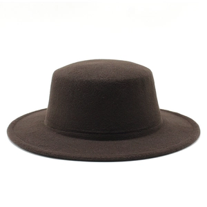 Detail of a dark brown wool felt flat top hat with a short brim and smooth texture