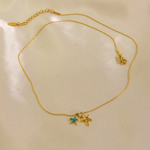Gold titanium starfish necklace with blue enamel star and sparkling zircon charms