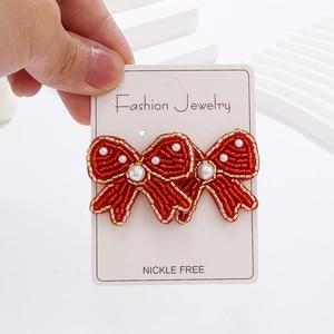Bohemian bow-shaped seed bead earrings with red beads and white pearl accents