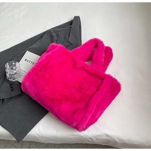 Detail of soft rose pink plush tote bag with furry handles for winter fashion outfits