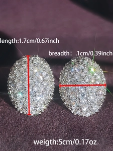 Detail view of oval copper stud earrings with sparkling pavé cubic zirconia